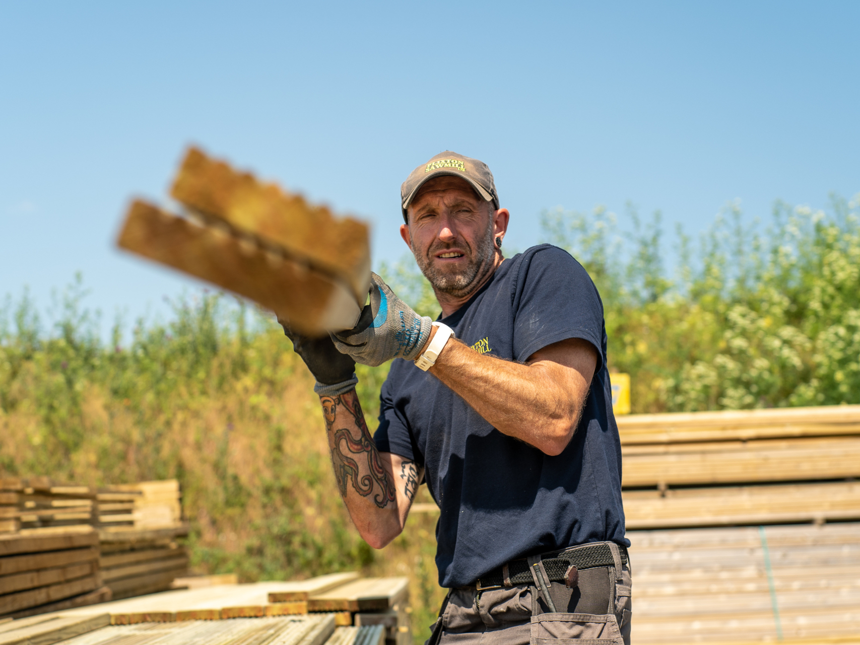 A man in uniform carrying wood