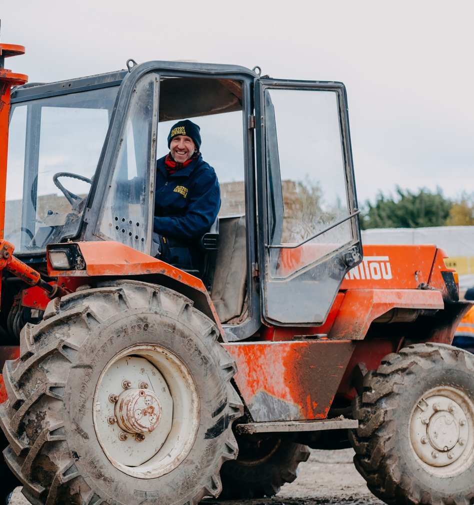 A portrait of a man driving a tractor